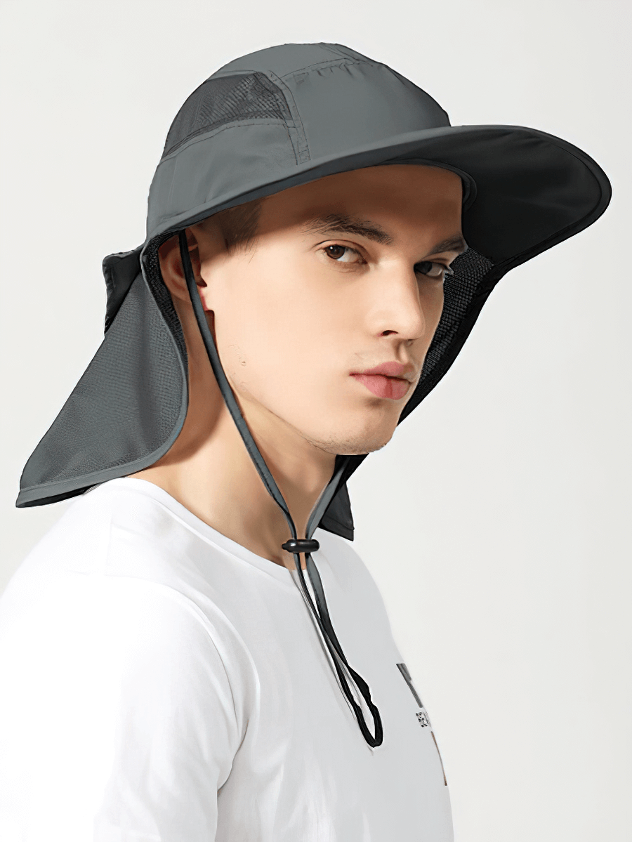 Man wearing a grey multi-functional wide-brimmed UV sun hat with neck protection, designed for maximum sun safety and comfort.